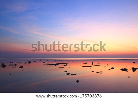 Sunset sky reflection over clear sea