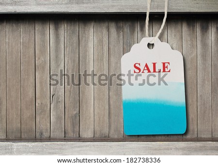 Blue label  paper or price tag on  brown wood background