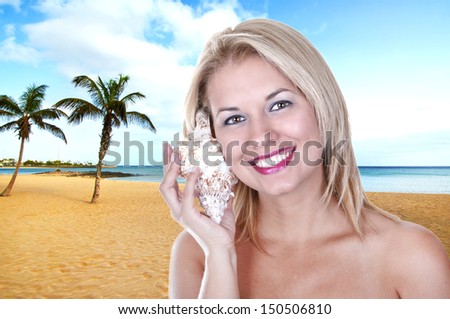 Beautiful woman listening shell sound on the beach.