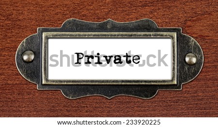 Private - file cabinet label, bronze holder against grunge and scratched wood