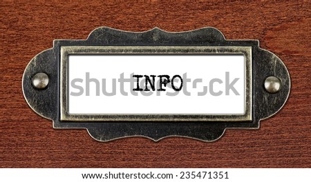 INFO - file cabinet label, bronze holder against grunge and scratched wood