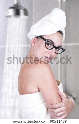 cute brunette with towel starting with her daily routine in bathroom