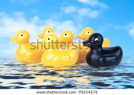 Rubber Duckies floating on water with blue sky