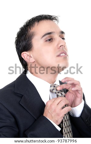 Portrait of a good looking businessman against white background straightens his tie