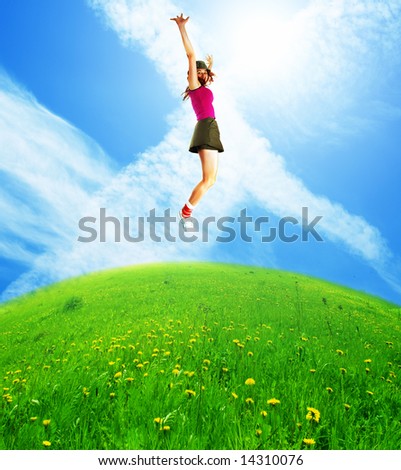 Happy jumping woman against the blue sky.