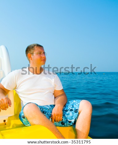 young man on the yacht. Against the sea