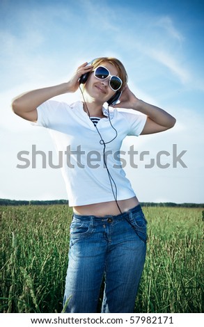 beautiful young woman outdoor listening to music