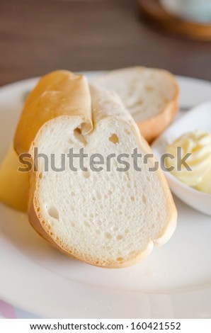 close up  slice of bread on white dish  served with cheese