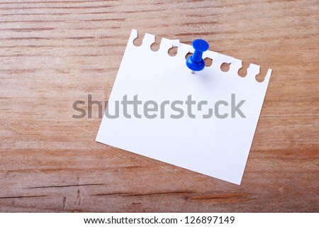 White note and pin on wooden ground/note/pin