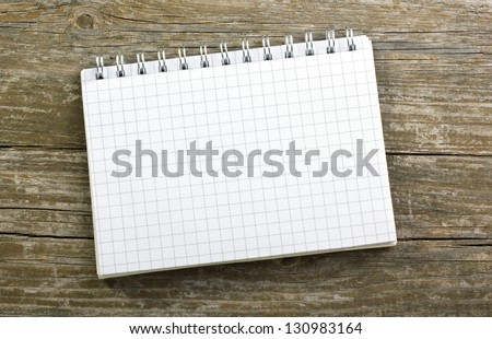 checked paper on wooden ground/checked paper/note book