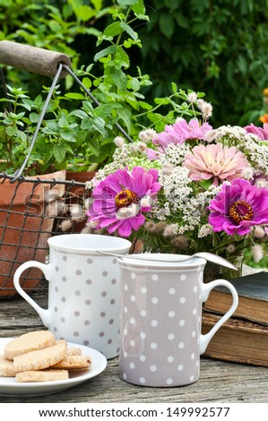 two coffee mugs old books and flowers/break/coffee mugs