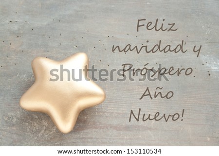 christmas card with golden star/Merry Christmas and a happy new year/spanish