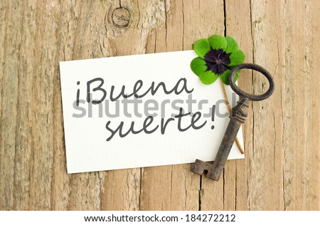 key, Lucky clover and card on  board/luck/spanish