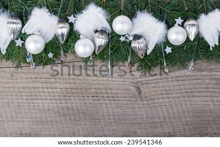 Pine green, baubles and angel wings on wooden background/christmas/angel wings