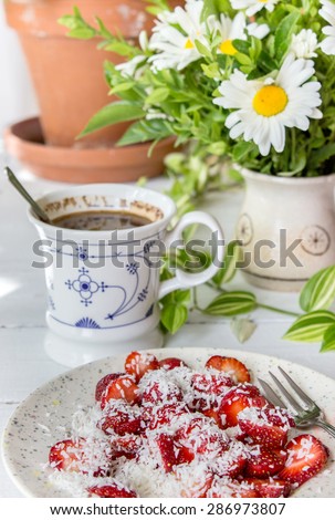 Table with strawberries, Coffee Cup and bouquet / Breakfast / strawberries