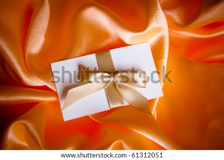 letter with golden ribbon on red satin