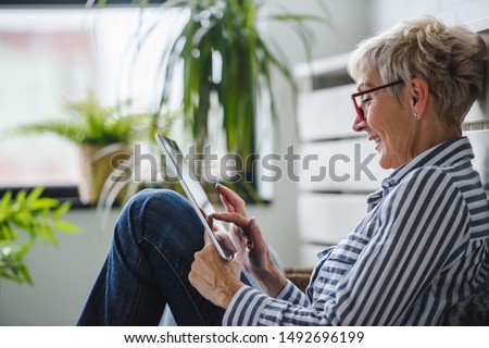 Similar – Image, Stock Photo Senior woman using tablet