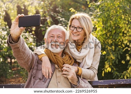 Similar – Image, Stock Photo Senior couple enjoying autumn colors together