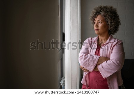 Similar – Image, Stock Photo Worried woman looking from the window of her flat, mental health concept in the city, depression with copy space