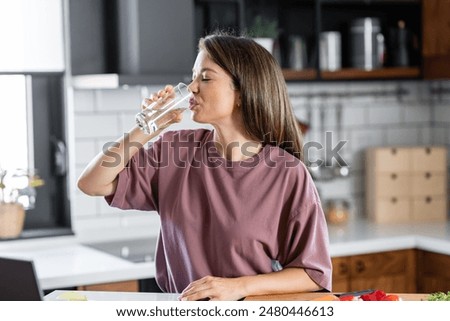 Similar – Image, Stock Photo Young woman drinking water while training on mat at home