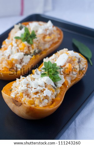 Baked squash with rice and sage on a tray