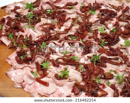 slices of pork loin with cherry tomatoes
