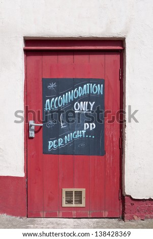 Accommodation Only Sign on a Red Door