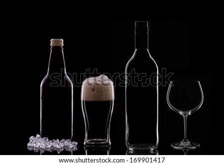 A Pint of Dark Beer, a Beer Bottle, a Wine Bottle and a Wine Glass on Black Background.