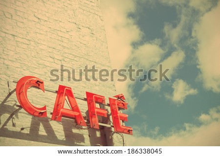 Red Cafe Sign Against Blue Sky with a Retro Effect