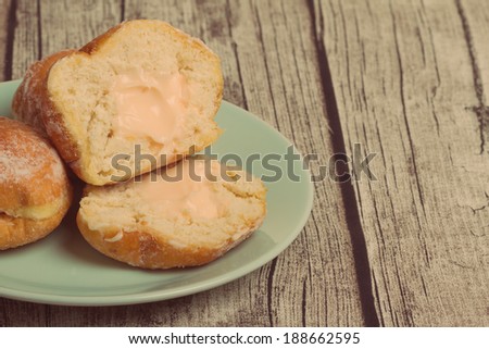 Donuts on Wooden Background with Retro Effect.Copy Space