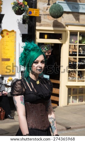 WHITBY, ENGLAND - April 25, 2015: Portrait of a Gothic Girl in the Street. Whitby Goth Weekend is a Twice-Yearly Music Festival for Goths, in Whitby, North Yorkshire, England