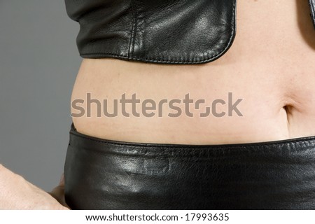 Woman wearing nothing but black leather over her naked body