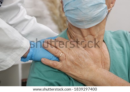 Portrait of elderly caucasian woman wearing protective medical mask. Care for the elderly people during corona virus outbreak, a helping hand, home care concept.