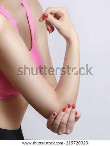 Acute elbow pain, Woman holds hand on his pain elbow.