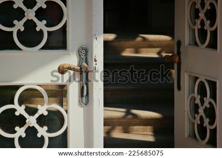 Close up of the iron door handle on the old wooden door