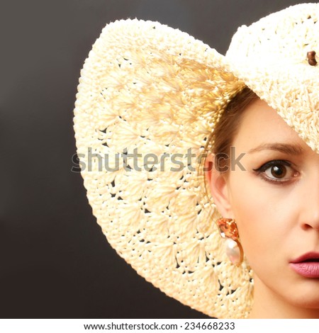Beautiful fashion model with big straw hat, Woman portrait wearing a big straw hat - partial face