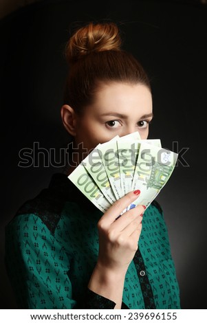 Woman holding euro bills, Close up of young woman covering her face with bunch of euro bills