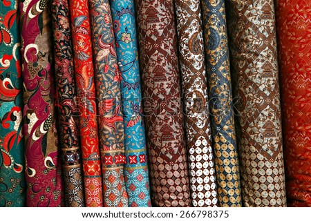 A variety of different bolts of traditional fabric, Colored brocade fabric in a traditional indonesian bazaar