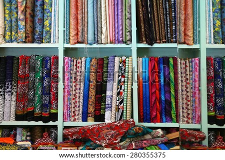 Fabric shop\
A variety of different bolt of  fabric displayed on shelves