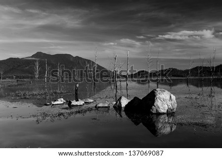 Scenic view of  with reflections of the blue sky and clouds, rocks in the water of Thailand, Black and white photography