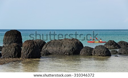 TRAT, THAILAND - APR 15  : Unidentified people at the canoe enjoyed the around the strange rock  at Koh Kham of Koh Mak on APRIL 15, 2011 in Trat,\
It is a sequence of three of the island in Trat