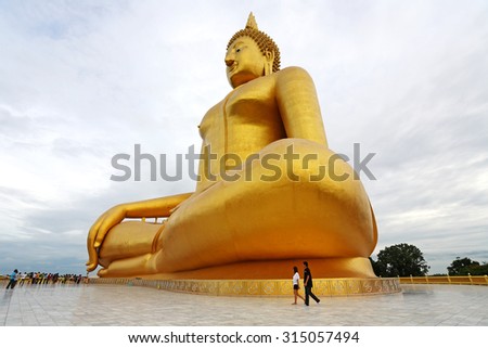 ANGTHONG, THAILAND - JUL 25: Unidentified people go to pray for big statue of buddha at Wat muang on July 25, 2010 in Angthong. It is a buddha statue sitting largest in Thailand