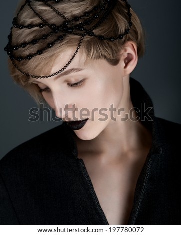 unusual portrait of a girl with black makeup and decoration