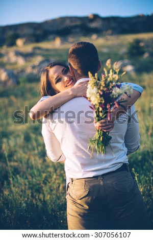 Young couple enjoying the sunset in the meadow. wedding style. romantic and love