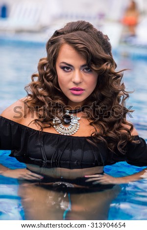 Young pretty fashion sport woman posing outdoor in summer on tropic island in hot weather in bikini on pool party