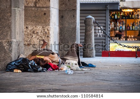 Homeless person sleeping on the street in Milan, Italy