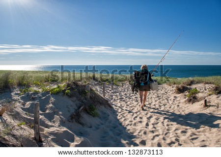 CAPE COD, MA - JUNE 19: A woman goes fishing at Race Point Beach on June 19, 2010 in Cape Cod. Cape Cod was the historic landing of Mayflower and is today a major travel destination in Massachusetts.