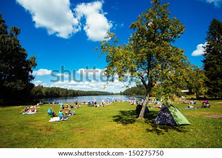 NORRKOPING, SWEDEN - AUGUST 4:  People enjoy a sunny day by lake Sorsjon in Norrkoping on August 4, 2013. Going to a lake for a swim is a typical leisure activity in Sweden at summertime.