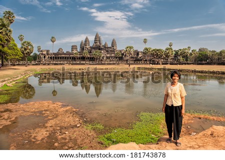 SIEM REAP, CAMBODIA Ã¢Â?Â? MARCH 10: Khmer woman posing in front Angkor Wat on March 10, 2009 in Siem Reap. Angkor Wat is a world famous UNESCO World Heritage site.