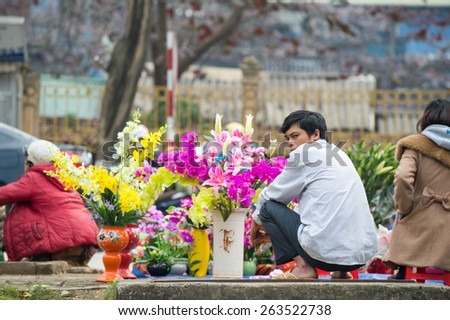 LAO CAI, VIETNAM - FEBRUARY 15: Vietnamese man sells flowers at a street market on February 15, 2015 in Lao Cai. The Lao Cai province is a major tourist destination in northern Vietnam.